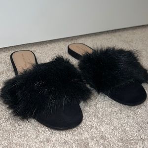 Black fluffy slides.